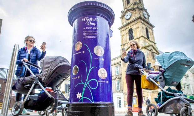Michelle Moir and Sara Casas at the Royal Mail postbox on Castle Wynd, Inverness, by the specially decorated postboxes to mark this year's Mother's Day