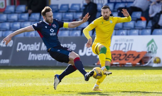 Keith Watson, left, battles for the ball with Martin Boyle