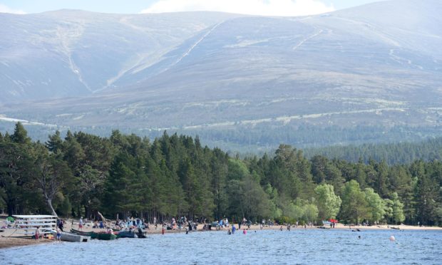 Visitors at Loch Morlich, overlooked by the Cairngorms, last summer