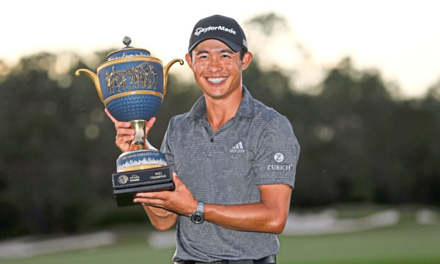 Collin Morikawa of the US celebrates with the championship trophy after winning the World Golf Championships - Workday Championship at The Concession golf tournament in Bradenton, Florida.