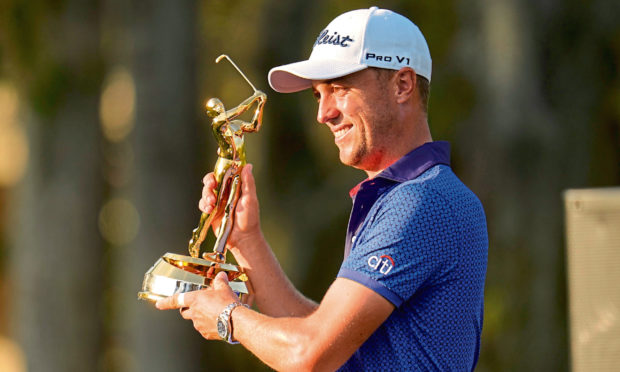 Justin Thomas holds the trophy after winning The Players Championship.