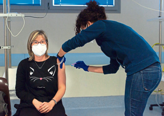 A healthcare worker administers Astra Zeneca Covid-19 Vaccine to a frontline workers