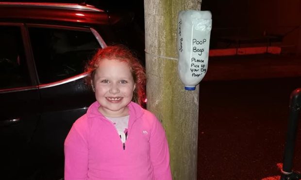 Aimee-Leigh Millar with her poop bag holder creations in New Pitsligo. Supplied by Emma-Russell