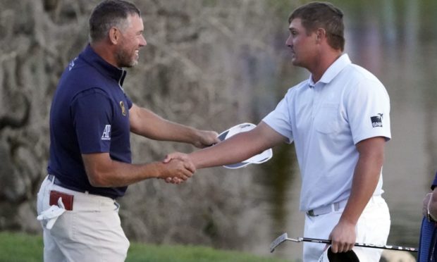 Lee Westwood and Bryson DeChambeau shake hands after they finished play in the Arnold Palmer Invitational.