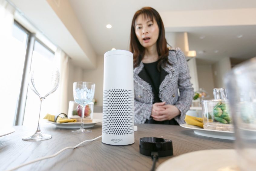 A woman interacts with Amazon Echo Plus.