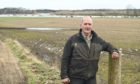 Farmer Angus Fettes is appealing for more maintenance to be undertaken on the River Spey to reduce flooding.