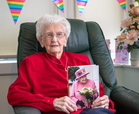 Mrs Robertson with her card from the Queen