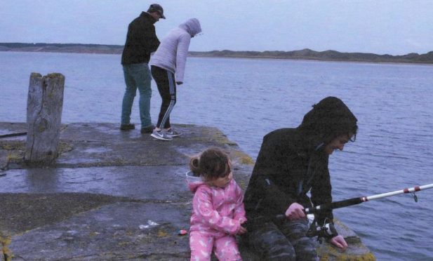 Muriel Murray showing her family fishing "completely unsuccessfully" in the rain at Castlehill harbour.