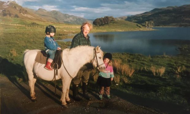 Katie Scobie on the horse, with her late father Ewen and sister Kim.