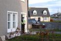 A police officer at the scene on Strachan Way, Peterhead. Picture by Paul Glendell