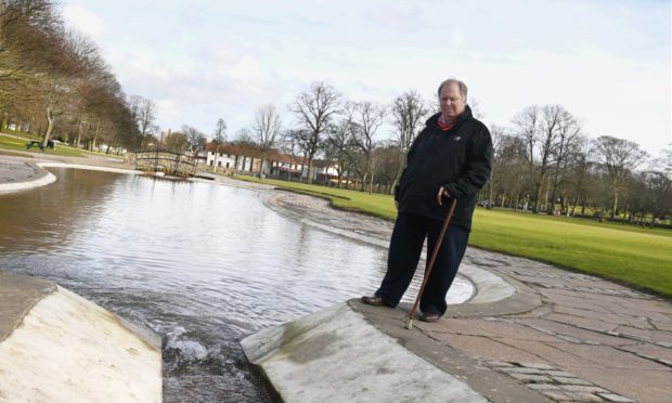Councillor Bill Cormie is concerned about the cost of clearing the pond in Westburn Park, which has been turned red-orange three times in recent weeks by silt.