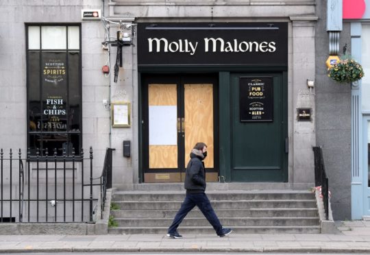 An empty Union Street on a Friday night. A man wearing a face mask walks past a boarded up Molly Malones. Covid-19. Lockdown.
16/05/2020
Picture by KATH FLANNERY