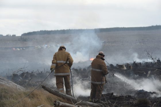 Firefighters deal with a wildfire near Dava in April 2019.