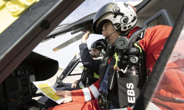 Scaa pilot Pete Winn and lead paramedic Ewan Littlejohn carry out checks on Helimed 79 in Aberdeen