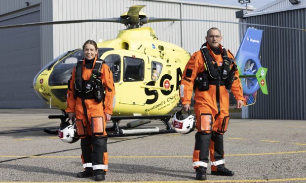 Scaa paramedic Laura McAllister and Ewan Littlejohn, team lead, in front of Helimed 79 at Aberdeen airport