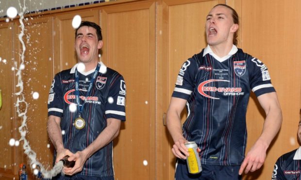 Brian Graham and Jackson Irvine celebrate Ross County beating Hibernian in the League Cup final. Image: SNS
