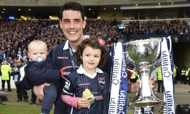 Former Ross County forward Brian Graham on the Hampden Park turf with his children.