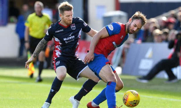 Caley Thistle skipper Sean Welsh takes on Ross County's Michael Gardyne in a Highland derby encounter in September 2018.