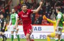 Andy Considine celebrates his goal against Hibs at Pittodrie a year ago.