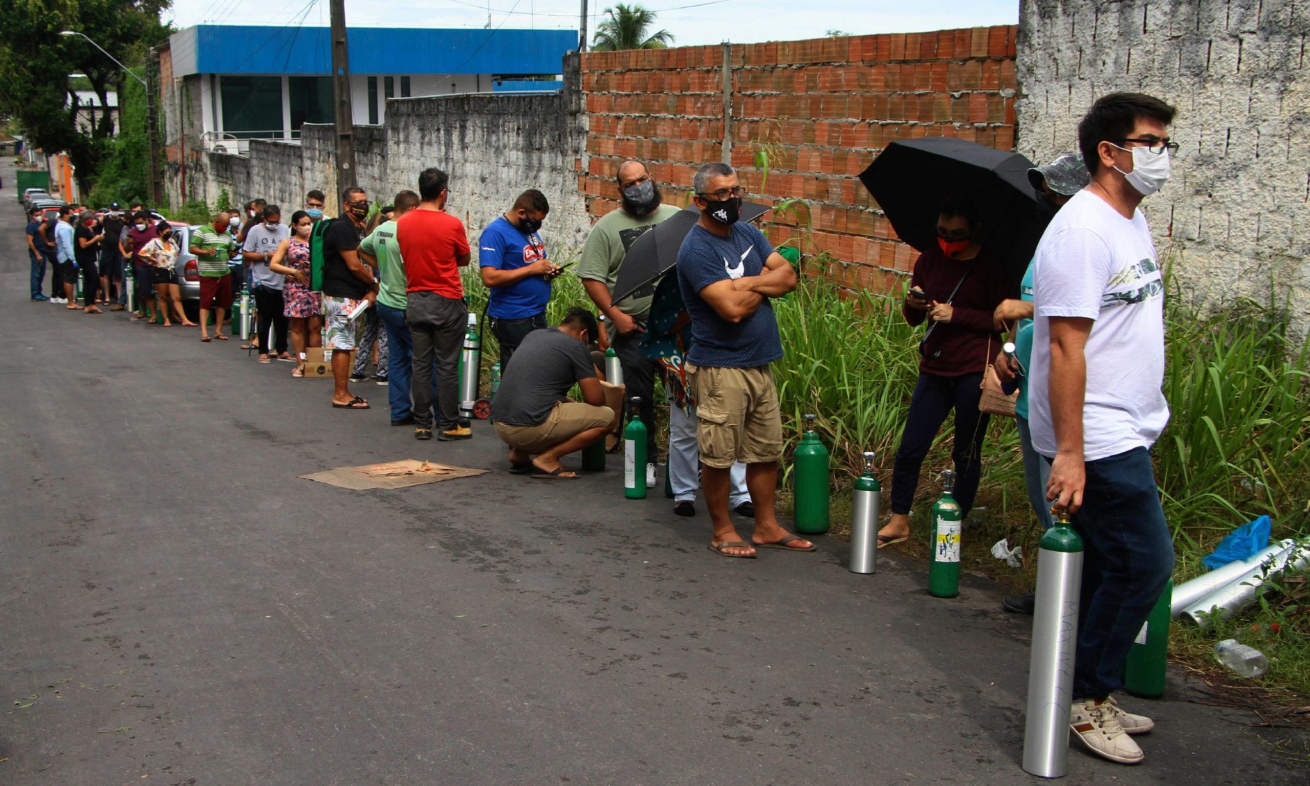 Family members of patients hospitalized with Covid-19 line up with empty oxygen tanks in an attempt to refill them, outside the Nitron da Amazonia company, in Manaus, Brazil.