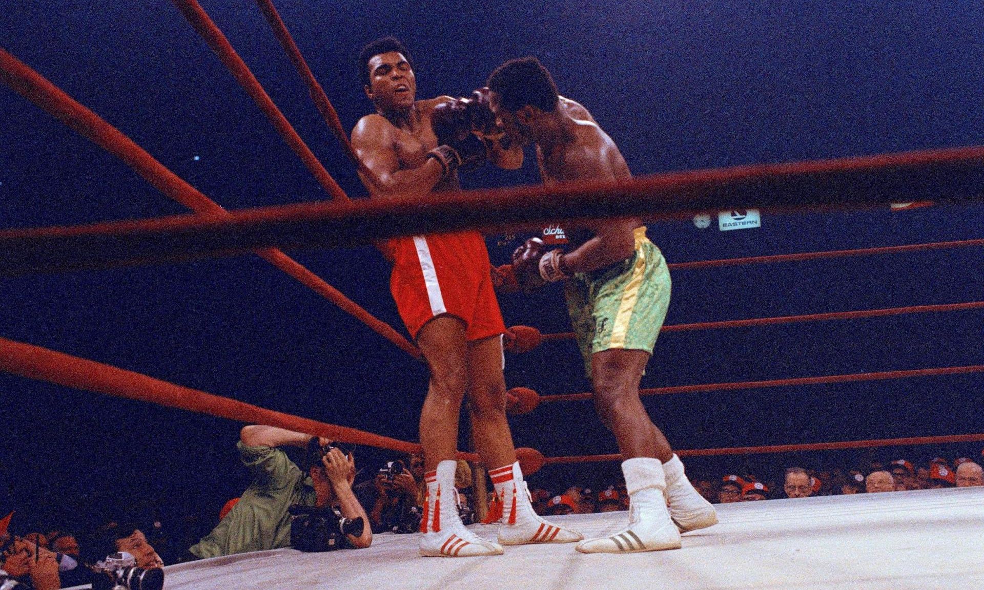 Muhammad Ali, red trunks, and Joe Frazier, green trunks, are shown during the middle rounds of their bout in New York's Madison Square Garden. 