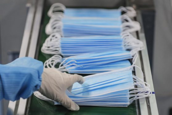 A worker produces protective face masks at a factory of the Naton Technology Group in Beijing