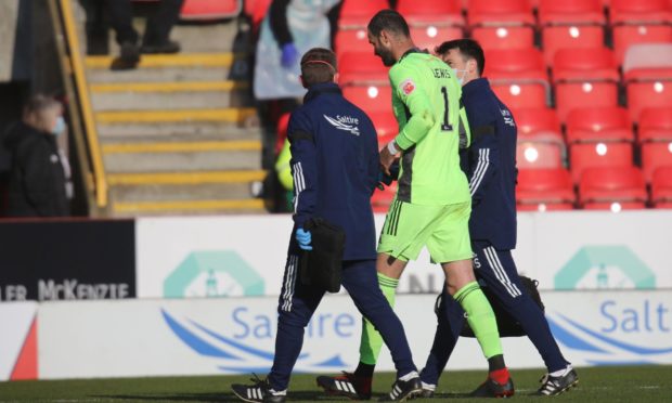 Aberdeen goalkeeper Joe Lewis is helped from the field.