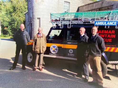 Prince Philip accepting the presentation of a new rescue vehicle with the Braemar Mountain Rescue team at Balmoral in 2014.