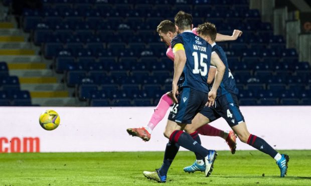 Inverness' Shane Sutherland scores his side's third goal during a Scottish against Ross County in Friday's third round tie.