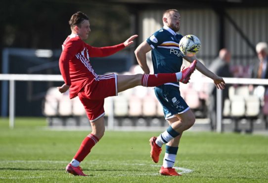 Formartine's Aaron Norris (left) competes with Motherwell's Allan Campbell.