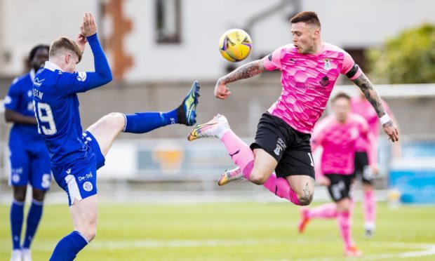 Queen of the South's 
Rhys Breen (L) and Inverness' Miles Storey in action.