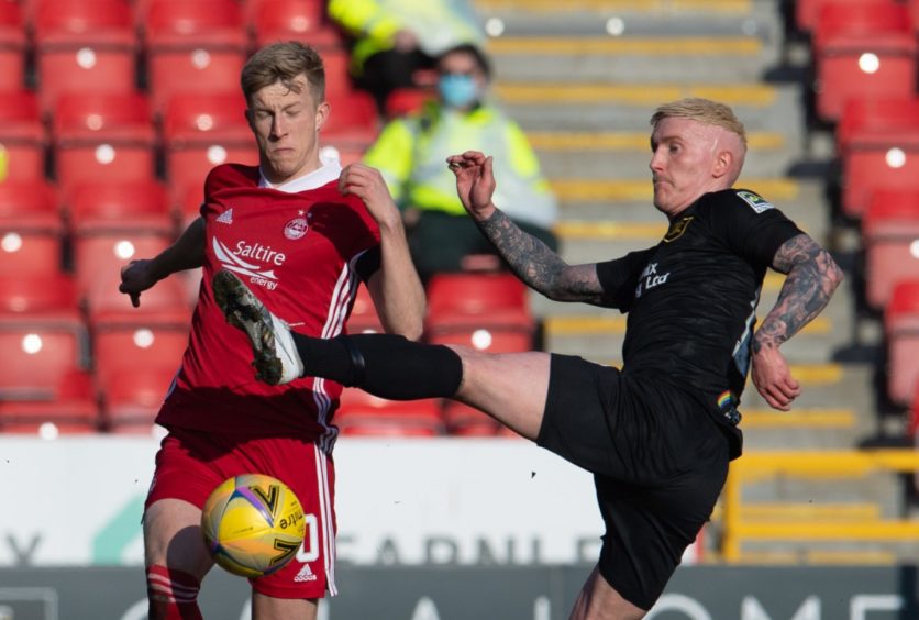 Aberdeen's Ross McCrorie (L) in action with Craig Sibbald of Livingston.