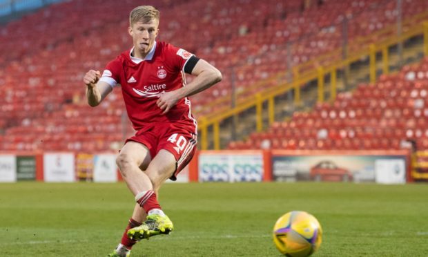 Ross McCrorie rolls home Aberdeen's winning penalty against Livingston.