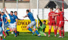 Stranraer celebrate scoring at Dudgeon Park as the Brora players watch on.