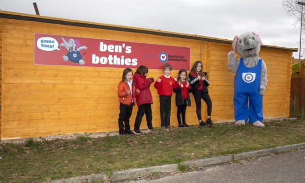 Youngsters with mascot outside one of the outdoor classroom at RAF Lossiemouth.