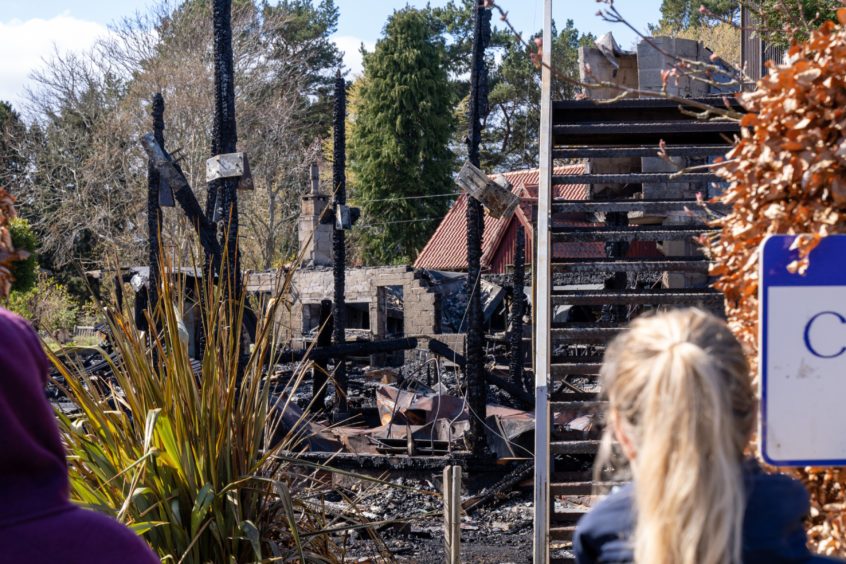 Only charred pillars and an external staircase are left of the Findhorn Foundation community centre.