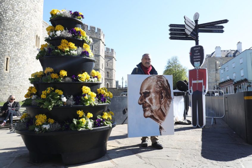 Artist Kaya Mar with a portrait of the Duke of Edinburgh, outside Windsor Castle, on the morning of the funeral of the Duke of Edinburgh taking place in St George's Chapel, at Windsor Castle, Berkshire, this afternoon. Picture date: Saturday April 17, 2021. PA Photo. See PA story FUNERAL Philip. Photo credit should read: Andrew Matthews/PA Wire