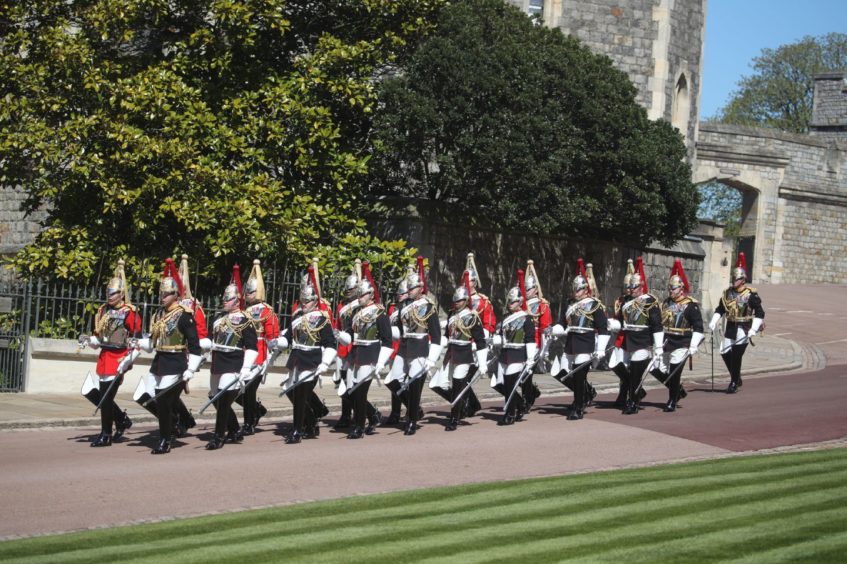 A dismounted detachment of The Life Guards and The Blues & Royals of The Household Cavalry arrive at Windsor Castle, Berkshire, ahead of the funeral of the Duke of Edinburgh. Picture date: Saturday April 17, 2021. PA Photo. See PA story FUNERAL Philip. Photo credit should read: Steve Parsons/PA Wire