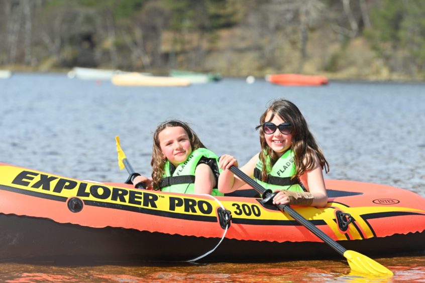 Lily and Poppy Kerr from Inverness enjoy the sun on Loch Morlich.
Picture by Jason Hedges.