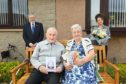 Willie and Helen Simpson celebrating their Diamond Wedding Anniversary with Deputy Lieutenant Joan Cowe and councillor John Cowe who presented the couple with cards and flowers.