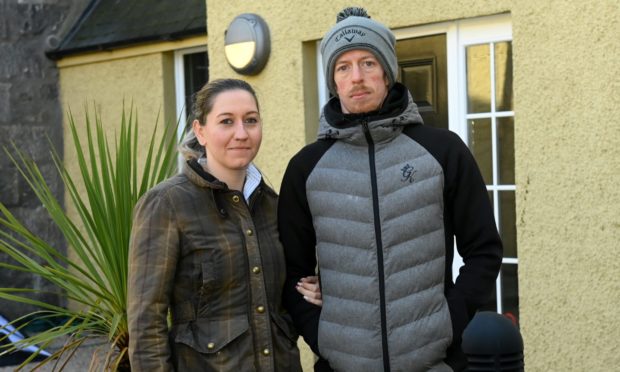 Kieren MacPhee and his partner Victoria Smith outside their city centre flat.