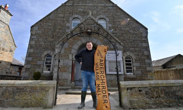 Chairman of the Friends of Aberchirder Village Hall, Claus Nielsen, with the new sign to go up inside the entrance of the hall, which he has made himself.