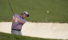Robert MacIntyre, of Scotland, hits out of a bunker on the 10th hole during a practice round for the Masters golf tournament.