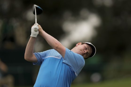 Robert MacIntyre, of Scotland, watches his tee shot on the third hole during the second round of the Masters.