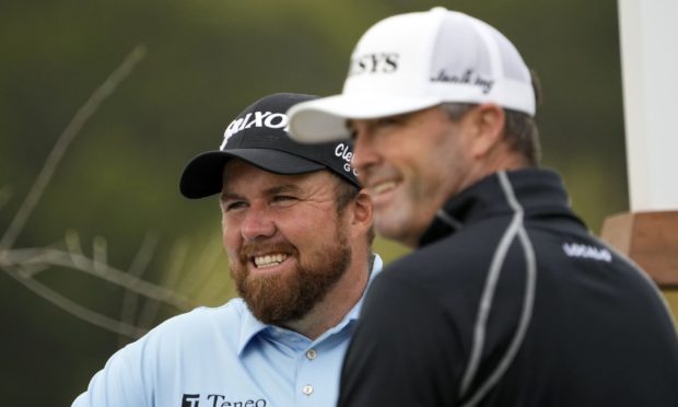 Shane Lowry, of Ireland, left.