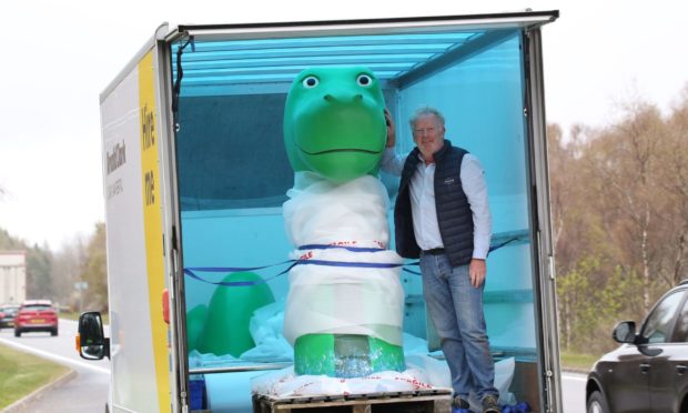 Paul O`Hare with the model of Nessie. Picture by Peter Jolly