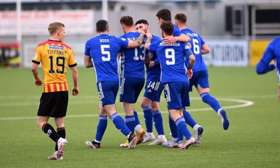 Cove Rangers players congratulate Rory McAllister on leveller.