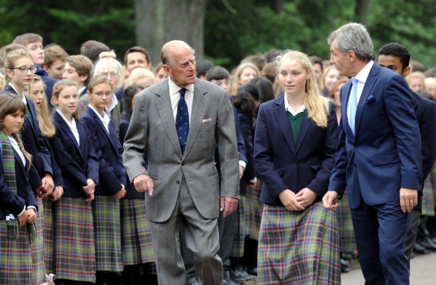 Prince Philip during a private visit to Gordonstoun, where he was a pupil, on the occasion of their 80th anniversary. L-R: Prince Philip, Olivia Tysoe, Guardian, Simon Reid, head teacher.Picture by Gordon Lennox 2014