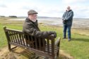 Jock Mitchell, foreground, chairman of Inver and District community council, with secretary Barry Brice in Inver Bay celebrating the award of funds for new seating