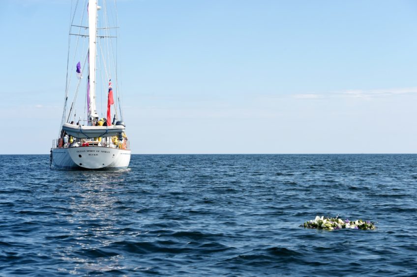 A piper played at Hopeman Harbour while a wreath was laid at sea to remember Prince Philip.